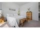Bright bedroom with a wooden bench at the foot of the bed and a 'love never fails' sign, exuding warmth and comfort at 6456 Kenzie Cir, Castle Pines, CO 80108