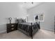 Cozy bedroom with a dark-colored iron bed, a nightstand, and a window at 6456 Kenzie Cir, Castle Pines, CO 80108