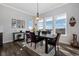 Elegant dining area with large windows offering scenic views and a stylish black dining table at 6456 Kenzie Cir, Castle Pines, CO 80108