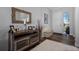 Charming foyer with rustic wood console table, mirror, and decorative accents at 6456 Kenzie Cir, Castle Pines, CO 80108
