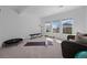 Bright exercise area with workout equipment and a comfortable wicker chair next to a view of the neighborhood at 6456 Kenzie Cir, Castle Pines, CO 80108