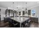 Spacious kitchen featuring a large island with seating and stainless steel appliances, perfect for Gathering gatherings at 6456 Kenzie Cir, Castle Pines, CO 80108