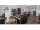 Open-concept living room with a fireplace and views into other rooms at 6456 Kenzie Cir, Castle Pines, CO 80108