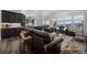Spacious living room featuring an open layout into the kitchen and dining area at 6456 Kenzie Cir, Castle Pines, CO 80108