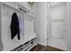 Convenient mudroom with coat rack, bench, and storage, adjacent to the laundry room at 6456 Kenzie Cir, Castle Pines, CO 80108