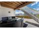 Outdoor patio area with cozy seating, a view of the backyard, and stairs leading to the second level at 6456 Kenzie Cir, Castle Pines, CO 80108