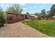 Landscaped backyard featuring a patio, lush lawn, mature trees, and ample privacy at 2588 S Flower Ct, Lakewood, CO 80227