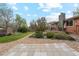 Well-manicured backyard with patio, lush greenery, stone accents, and mature trees at 2588 S Flower Ct, Lakewood, CO 80227