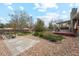 Lush backyard featuring a spacious deck, mature trees, and landscaped garden beds at 2588 S Flower Ct, Lakewood, CO 80227