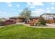 Spacious backyard with a well-maintained lawn, patio, and mature landscaping at 2588 S Flower Ct, Lakewood, CO 80227