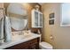 This bathroom features a large round mirror and ample cabinet space at 2588 S Flower Ct, Lakewood, CO 80227