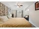 Cozy bedroom features a ceiling fan, bright window and neutral carpet at 2588 S Flower Ct, Lakewood, CO 80227