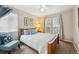 This bedroom features natural lighting, a ceiling fan, and calming color accents at 2588 S Flower Ct, Lakewood, CO 80227