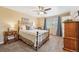 This bedroom features a ceiling fan, natural lighting, and a vintage-style bed frame at 2588 S Flower Ct, Lakewood, CO 80227