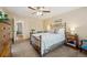 This bedroom features a ceiling fan, natural lighting, and a vintage-style bed frame at 2588 S Flower Ct, Lakewood, CO 80227