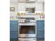 Modern kitchen features stainless steel appliances, blue cabinets, and bright countertops with an oven at 2588 S Flower Ct, Lakewood, CO 80227