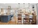 Modern kitchen featuring stainless steel appliances, granite countertops, and a breakfast bar at 2588 S Flower Ct, Lakewood, CO 80227