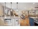 Bright kitchen with white cabinets, granite countertops, stainless steel appliances, and a view to the living room at 2588 S Flower Ct, Lakewood, CO 80227