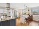 Modern kitchen with granite counters, stainless appliances, and center island with bar seating at 2588 S Flower Ct, Lakewood, CO 80227