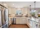 Bright kitchen featuring stainless steel appliances, granite countertops, and ample cabinet space at 2588 S Flower Ct, Lakewood, CO 80227