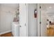 This laundry room features a white washer, dryer, shelving, and hanging rack at 2588 S Flower Ct, Lakewood, CO 80227