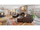 Inviting living room features a cozy fireplace, comfortable leather seating, and an open-concept design to the kitchen at 2588 S Flower Ct, Lakewood, CO 80227