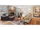 Cozy living room features a brick fireplace, wood floors, and comfortable seating at 2588 S Flower Ct, Lakewood, CO 80227