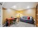 Home office space with gray sofa, a lamp, and desk area at 2588 S Flower Ct, Lakewood, CO 80227