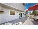 Inviting back deck with sliding glass doors, an umbrella for shade, and space for comfortable outdoor seating at 13464 Vine St, Thornton, CO 80241