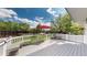 Spacious back deck with white railing, benches, and a red umbrella, ideal for outdoor entertaining and relaxation at 13464 Vine St, Thornton, CO 80241