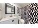 Well-lit bathroom with a modern mirror, stylish fixtures, and a patterned shower curtain at 13464 Vine St, Thornton, CO 80241