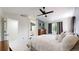 This bedroom features a ceiling fan, large window, and ensuite bathroom with a mounted TV at 13464 Vine St, Thornton, CO 80241
