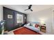 Cozy bedroom with a ceiling fan, window, and a comfortable futon on an orange rug at 13464 Vine St, Thornton, CO 80241