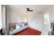 Bedroom with a ceiling fan, window, futon, a large closet and an orange rug at 13464 Vine St, Thornton, CO 80241