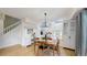 Open dining area with modern chandelier next to a study area and staircase at 13464 Vine St, Thornton, CO 80241