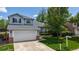 Inviting front exterior featuring a well-maintained lawn and a spacious two-car garage at 13464 Vine St, Thornton, CO 80241