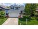 Charming two-story home featuring a two-car garage and a well-manicured lawn at 13464 Vine St, Thornton, CO 80241