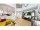 Bright, open living room with hardwood floors and an open view of the kitchen and stairs at 13464 Vine St, Thornton, CO 80241
