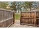 Private back yard with a wooden fence and a peek through to the community green space at 1941 Newland Ct, Lakewood, CO 80214