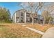 A two story townhome features a sidewalk and is framed by beautiful trees at 1941 Newland Ct, Lakewood, CO 80214