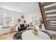 Open living area with dining space, fireplace, and staircase at 1941 Newland Ct, Lakewood, CO 80214