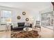 Comfortable living room with a leather couch, sliding glass doors, and neutral tones at 1941 Newland Ct, Lakewood, CO 80214