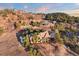 Aerial shot of a beautiful property with mountain views and lots of trees at 1052 Country Club Estates Dr, Castle Rock, CO 80108