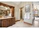 The bathroom features a vanity, luxurious stone floors, and a view of the living room at 1052 Country Club Estates Dr, Castle Rock, CO 80108