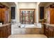 A beautifully designed bathroom with a jacuzzi tub situated under a large window with beautiful views at 1052 Country Club Estates Dr, Castle Rock, CO 80108
