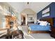 Spacious bedroom features a fireplace, a sitting chair, and decoratively painted accent wall at 1052 Country Club Estates Dr, Castle Rock, CO 80108
