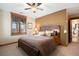 Bedroom features a wooden bed frame, a ceiling fan, and a scenic view through the window at 1052 Country Club Estates Dr, Castle Rock, CO 80108