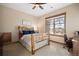 Bedroom with a log-framed bed, an office nook, and a large window with a scenic view at 1052 Country Club Estates Dr, Castle Rock, CO 80108