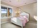 Bedroom with white furniture, pink accents, and a large window with scenic views at 1052 Country Club Estates Dr, Castle Rock, CO 80108
