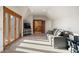 Bright Bonus room with balcony doors, a comfortable couch, and a staircase entrance at 1052 Country Club Estates Dr, Castle Rock, CO 80108